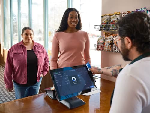 Photo of customers checking out at a retail POS counter